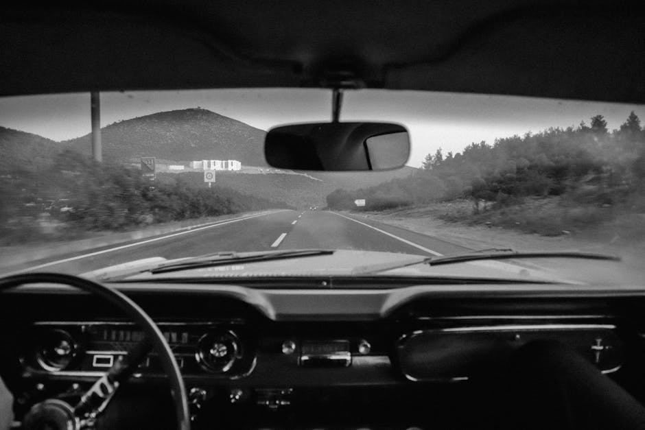 Classic car drive on open road, seen from the dashboard. Atmospheric and timeless.