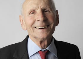 Portrait of a happy senior man in a suit. Ideal for lifestyle and senior care imagery.